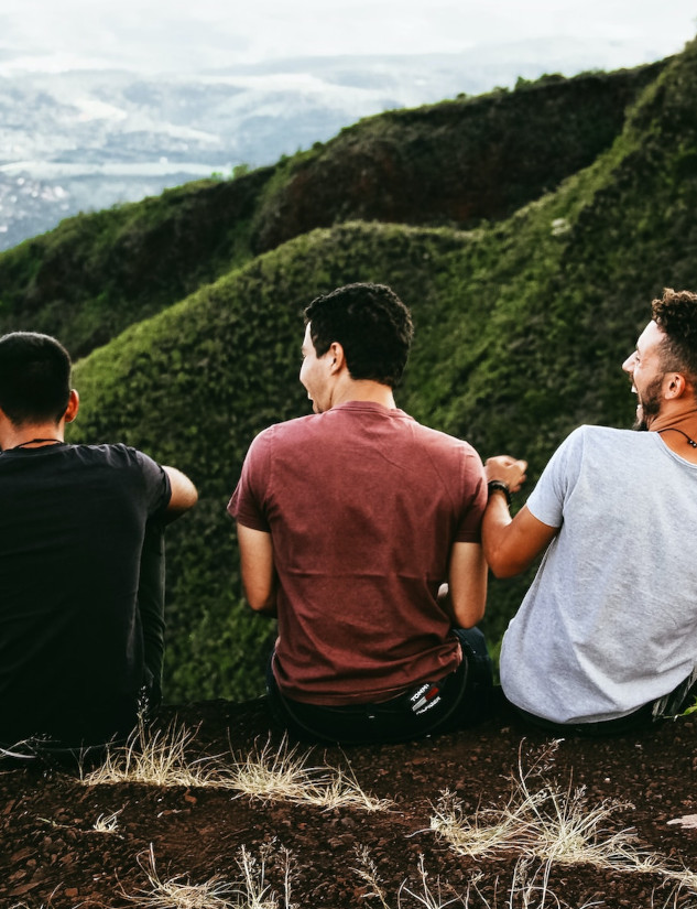 Three friends sitting and laughing